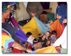 Kids spinning in parachute.